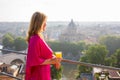 Woman in morning standing on terrace overlooking city Royalty Free Stock Photo