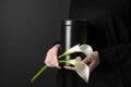 Woman with mortuary urn and flowers on dark background, closeup Royalty Free Stock Photo