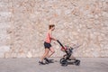 Woman, mother doing fitness pushing the baby stroller Royalty Free Stock Photo