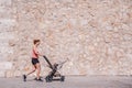 Woman, mother doing fitness pushing the baby stroller Royalty Free Stock Photo