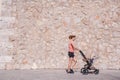 Woman, mother doing fitness pushing the baby stroller Royalty Free Stock Photo