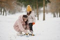 Woman mother helps her child stand children& x27;s skis Royalty Free Stock Photo