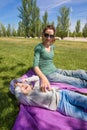 Mother tickling litlle child in park