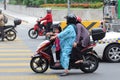 Woman on motorbike with her pillion riders
