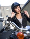 Young Woman on motorcycle adjusts helmet Royalty Free Stock Photo