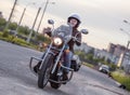 Woman motorcyclist riding on her chopper motorcycle on roads