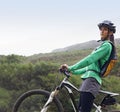 Woman, mountain bike and thinking in nature, fitness and helmet for safety, adventure and mock up space. Girl, bicycle Royalty Free Stock Photo