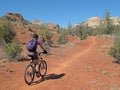 Woman mountain biking in the red rocks, Sedona, USA Royalty Free Stock Photo