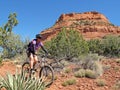 Woman mountain biking in the red rocks, Sedona, USA Royalty Free Stock Photo