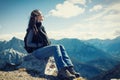 Woman on mountain hike having rest sitting on rock