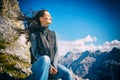 Woman on mountain hike resting, her hair blowing in wind Royalty Free Stock Photo