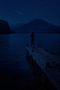 woman and mountain lake at night mysterious star moon sky Royalty Free Stock Photo