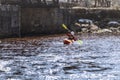 A woman on a mountain river is engaged in rafting. A girl is kayaking down a mountain river.girl in a kayak, side view Royalty Free Stock Photo