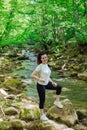 woman by a mountain river in a green forest travel hike Royalty Free Stock Photo