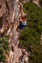 Woman, mountain and rock climbing for fitness in outdoors, challenge and rope for training. Female person, cliff and Royalty Free Stock Photo