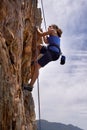 Woman, mountain and rock climbing for hiking in outdoors, challenge and rope for training. Female person, cliff and Royalty Free Stock Photo