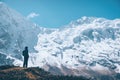 Woman on the mountain trail and looking on snow covered rocks Royalty Free Stock Photo