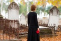 Woman in Mourning Walking in Cemetery