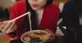 Woman, mouth and blowing ramen noodles in restaurant for dinner, diet and meal in cafeteria. Closeup, hungry lady and Royalty Free Stock Photo