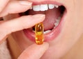 Woman mouth eating pills.