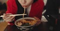 Woman, mouth and eating ramen in restaurant for dinner, meal and noodles in cafeteria. Closeup, hungry lady and Royalty Free Stock Photo