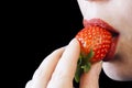 Woman mouth eating strawberry Royalty Free Stock Photo