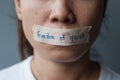 Woman with mouth sealed in adhesive tape with Freedom of Speech message., freedom of press, Human rights, Protest dictatorship,