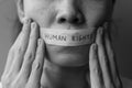 Woman with mouth sealed in adhesive tape with Human rights message. Free of speech, freedom of press, Protest dictatorship,