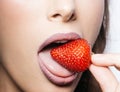 Woman mouth with sexy lips eating red sweet strawberry berry fruit, closeup. Royalty Free Stock Photo