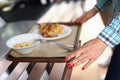 Woman move food tray in self-service restaurant. Royalty Free Stock Photo