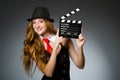 Woman with movie clapboard against Royalty Free Stock Photo