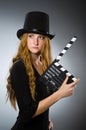 Woman with movie clapboard against Royalty Free Stock Photo