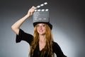 Woman with movie clapboard against Royalty Free Stock Photo