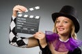 Woman with movie clapboard against Royalty Free Stock Photo