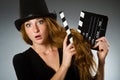 Woman with movie clapboard against