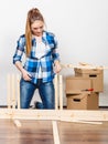 Woman moving in assembly furniture at new home. Royalty Free Stock Photo