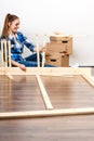 Woman moving in assembly furniture at new home. Royalty Free Stock Photo