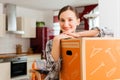 Woman with moving box in her house