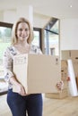 Woman Moving Into New Home With Packing Box Royalty Free Stock Photo