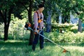 Woman mowing the grass in garden. Lawn care concept Royalty Free Stock Photo