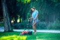 Woman mowing lawn in residential back garden Royalty Free Stock Photo