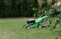 woman mows the lawn mower