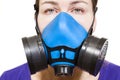 Woman in multi-purpose respirator half mask for toxic gas protection. Front view, isolated on white background Royalty Free Stock Photo