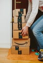 Woman and multiple Amazon cardboard boxes
