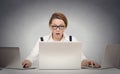 Woman multitasking working on several computers