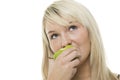 Woman munching on a green apple