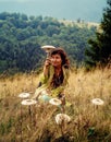 Woman with mushroom, on mountain meadow, mushroom as a umbrella.