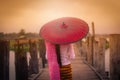 Woman Myanmar holding traditional red umbrella on U Bein wooden