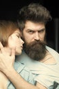 Woman on mysterious face with bearded man, black background. Fashion shot of couple after haircut. Barbershop concept Royalty Free Stock Photo