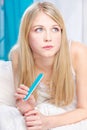 Woman with nail file in bedroom